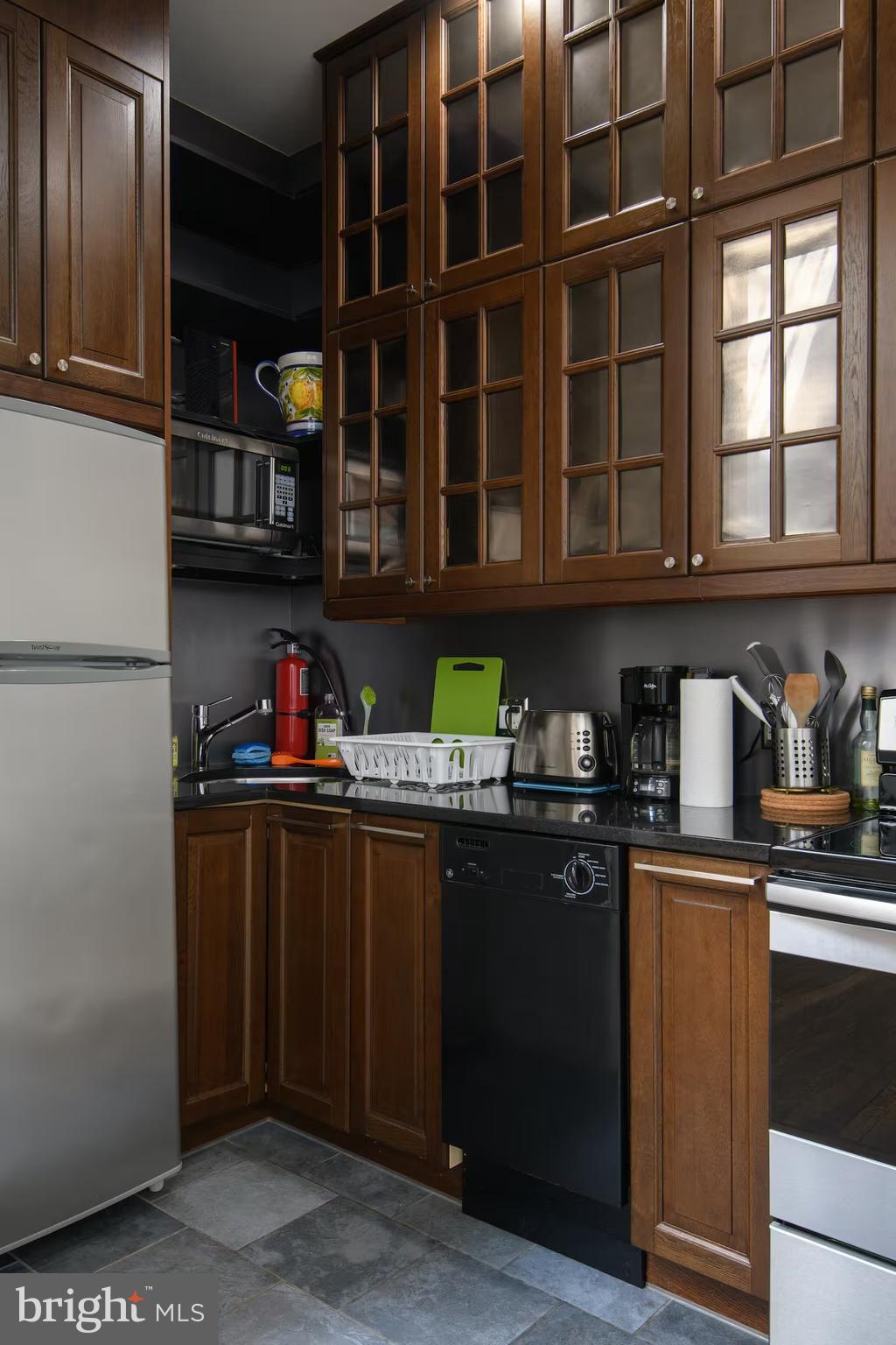 114 Llanfair Road Ardmore, PA 19003 - Photo 64 of 80 a kitchen with stainless steel appliances granite countertop a refrigerator and a sink
