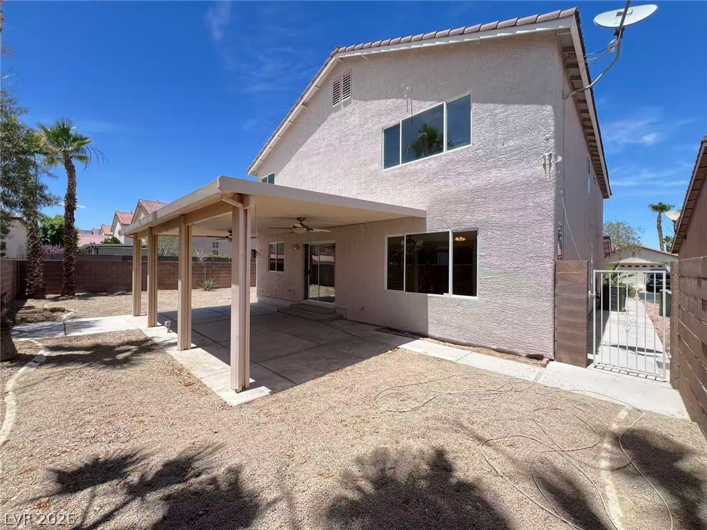 9891 Ridge Hill Avenue Las Vegas, NV 89147 - Photo 28 of 29 An inviting covered patio extends from this home, providing a cool retreat in the arid landscape.