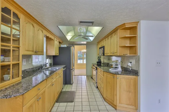 a kitchen with stainless steel appliances granite countertop a sink and cabinets