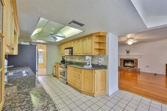 a kitchen with stainless steel appliances granite countertop a refrigerator and a sink