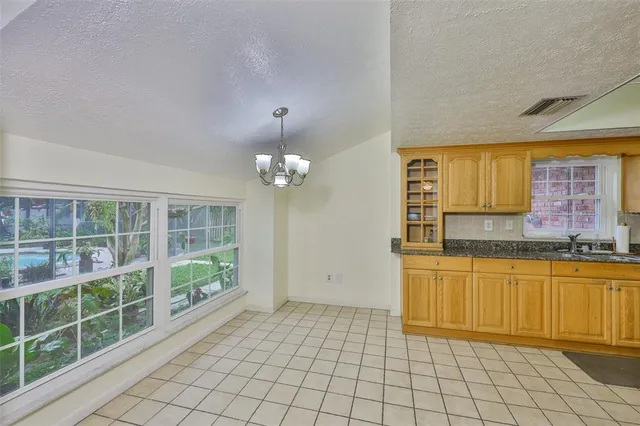 a spacious bathroom with a granite countertop sink and a mirror