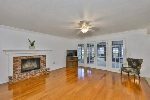 a living room with fireplace furniture and a wooden floor