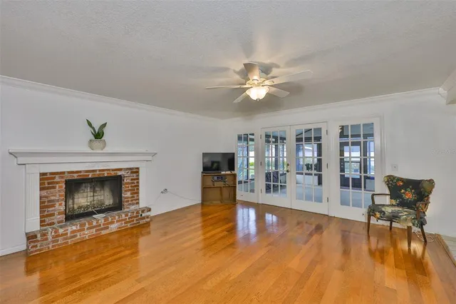 a living room with fireplace furniture and a wooden floor