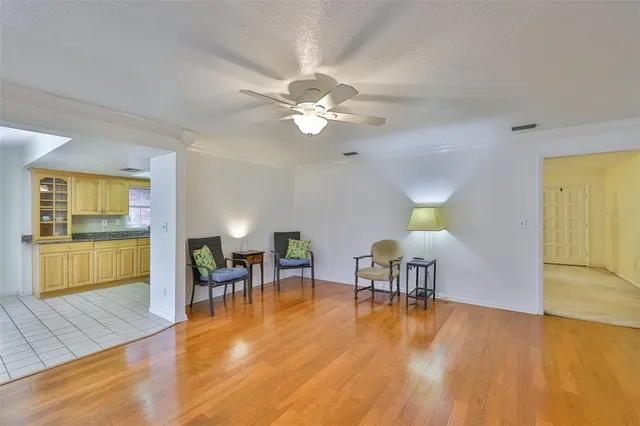 a living room with furniture and a kitchen view