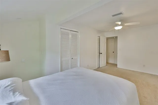 a bedroom with a bed and a lamp