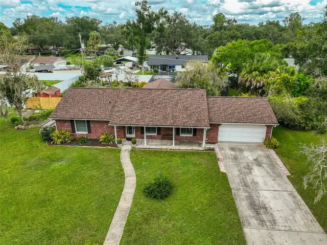 an aerial view of a house with yard swimming pool and outdoor seating