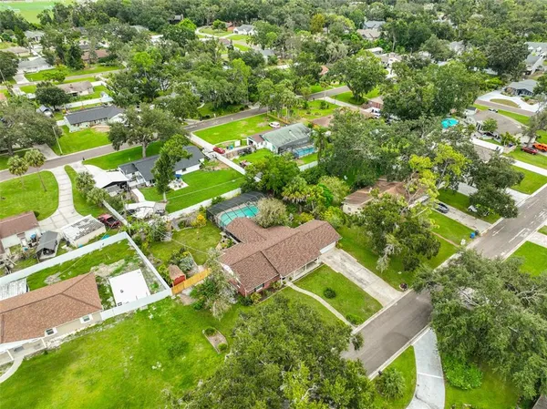 an aerial view of residential houses with outdoor space and street view