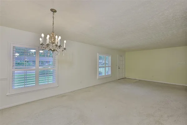 a view of a chandelier in a room with a window