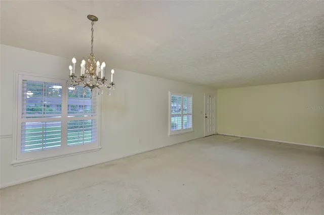 a view of a chandelier in a room with a window
