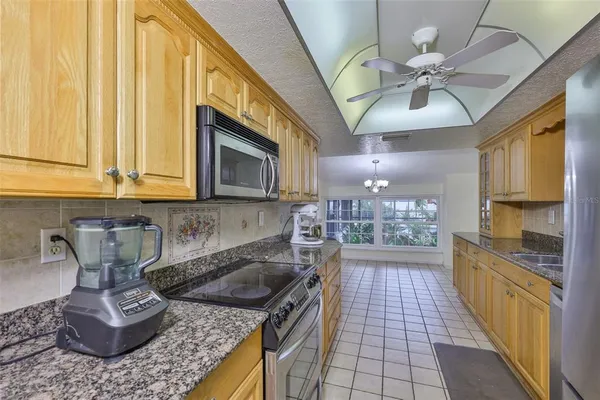 a kitchen with a stove a sink and cabinets