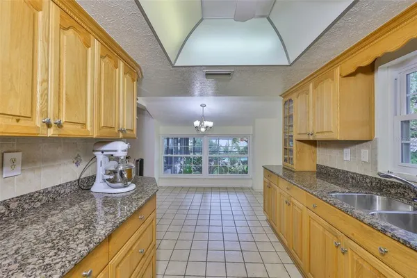 a kitchen with a large window appliances and cabinets