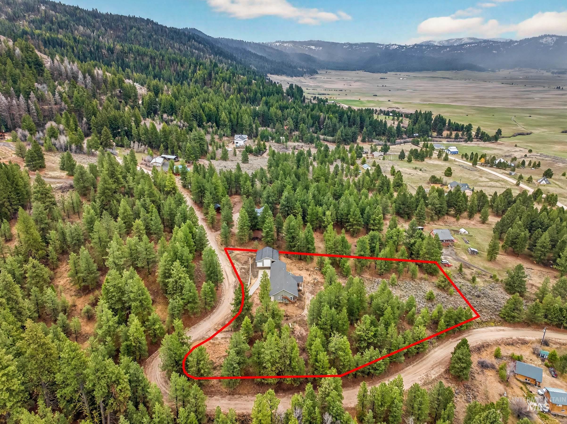 10191 Timberrim Drive Cascade, ID 83611 - Photo 40 of 44 Aerial view of property's location featuring a mountain backdrop and property boundaries highlighted