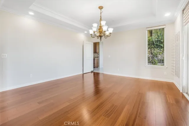 an empty room with wooden floor and outdoor view