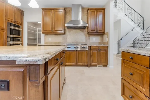 a spacious bathroom with a granite countertop sink and a mirror