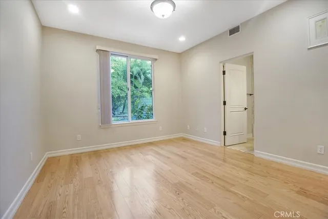 a view of a room with wooden floor
