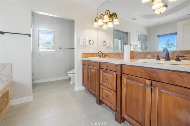 a spacious bathroom with a tub sink and mirror
