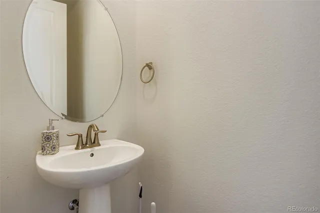 a bathroom with a sink a mirror and a toilet