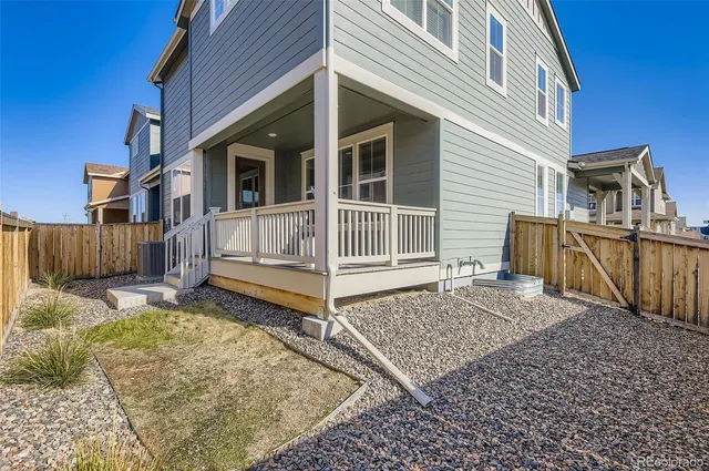 a view of a house with a wooden fence