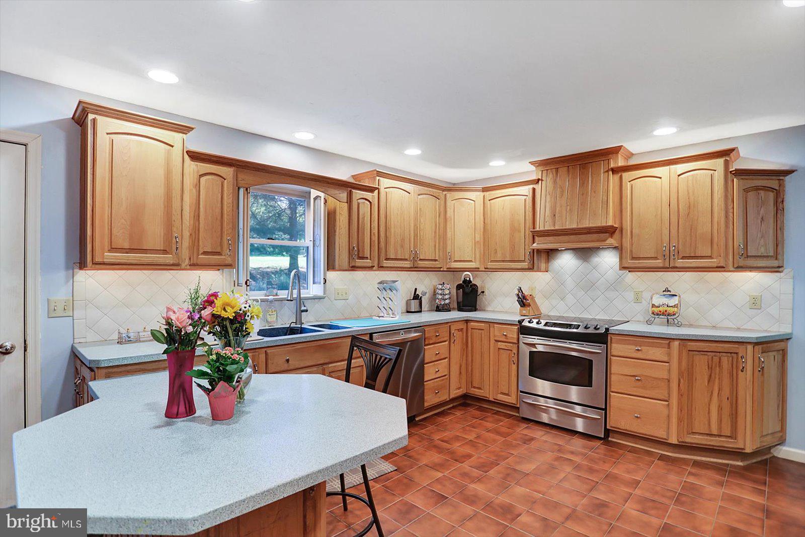63 Lindsay Lane Hanover, PA 17331 - Photo 15 of 39 a kitchen with stainless steel appliances granite countertop a stove top oven a sink dishwasher and cabinets with wooden floor
