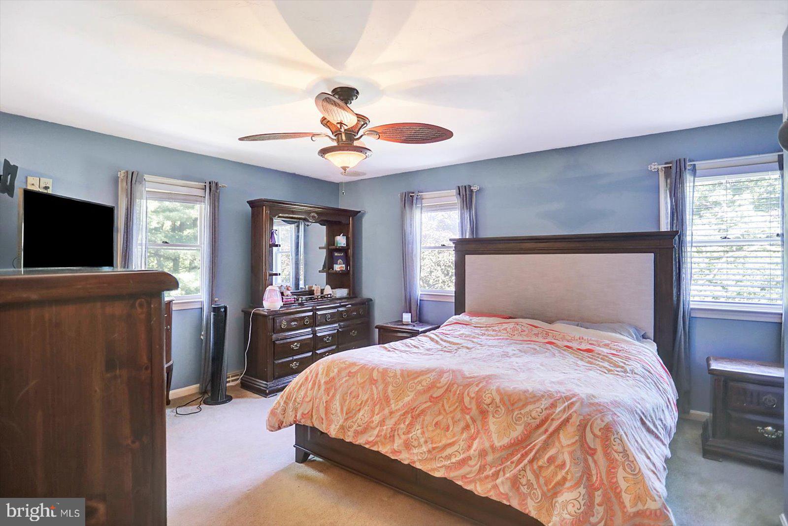 63 Lindsay Lane Hanover, PA 17331 - Photo 24 of 39 a bedroom with a large bed a flat tv screen and dresser