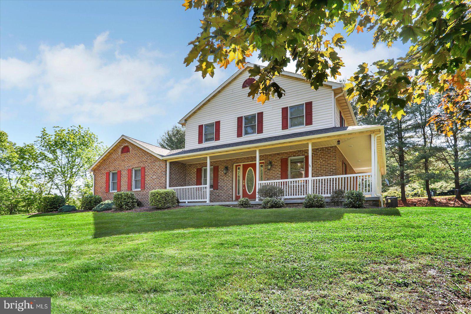 63 Lindsay Lane Hanover, PA 17331 - Photo 8 of 39 a front view of a house with a garden and trees