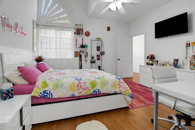 a bedroom with a bed and flat screen tv