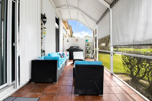 a view of a patio with table and chairs a barbeque