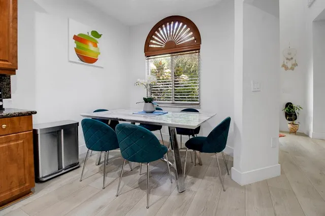 a view of a dining room with furniture and a window