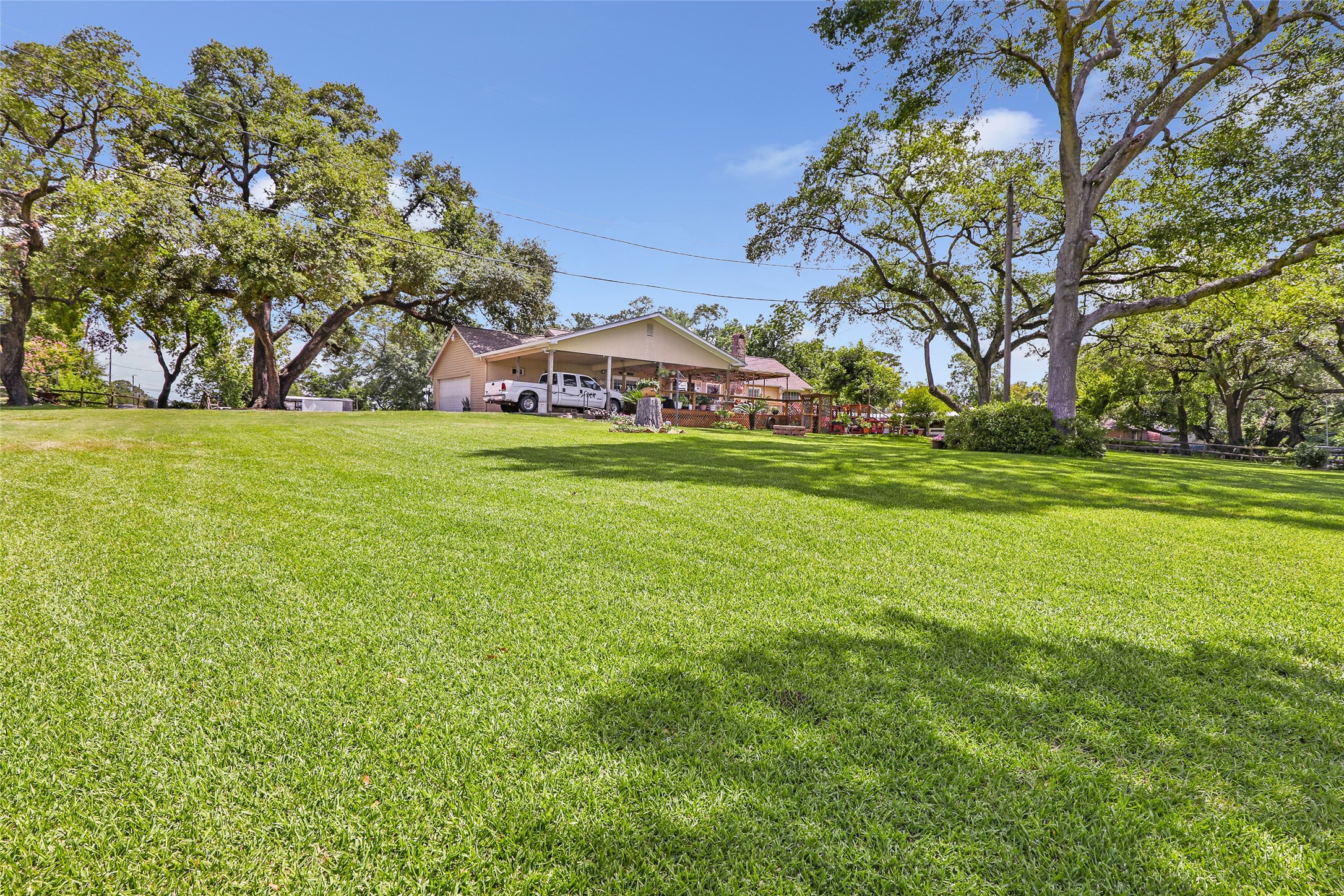 111 South 8th Street Highlands, TX 77562 - Photo 12 of 50 a backyard of a house with lots of green space and fountain