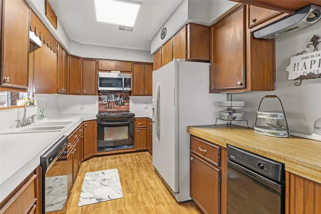 a kitchen with sink cabinets and wooden floor