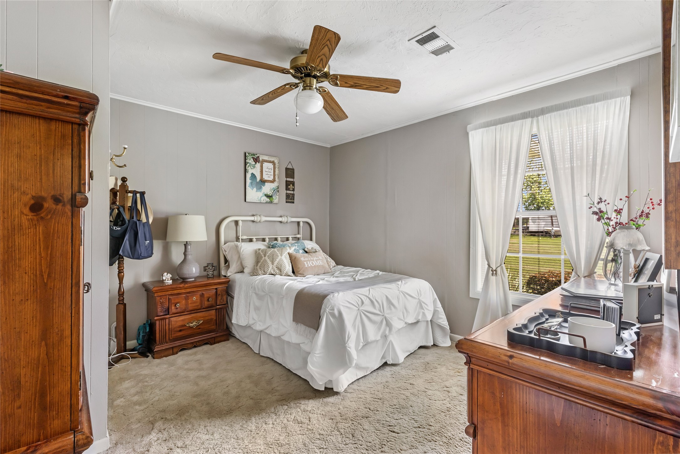 111 South 8th Street Highlands, TX 77562 - Photo 32 of 50 a bedroom with a bed and a chandelier