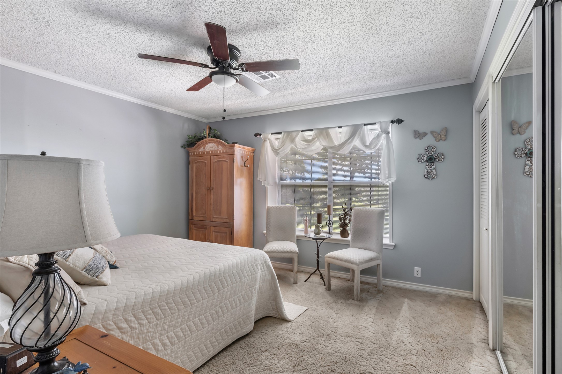 111 South 8th Street Highlands, TX 77562 - Photo 35 of 50 a bedroom with a bed and a chandelier