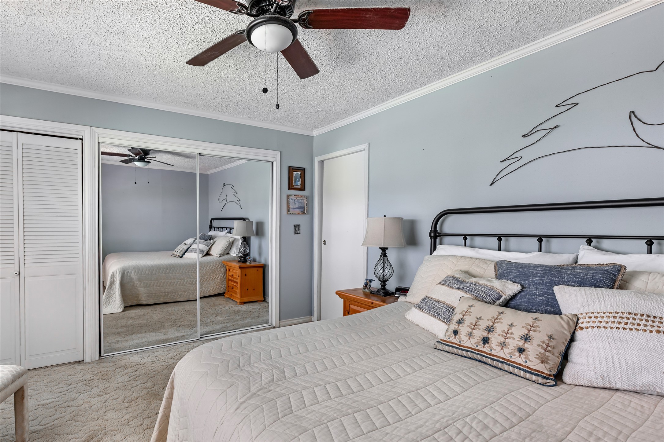 111 South 8th Street Highlands, TX 77562 - Photo 36 of 50 a bedroom with a bed and ceiling fan