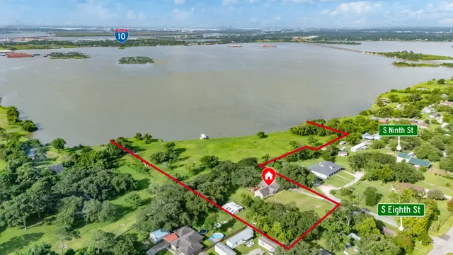 a view of a house with a yard and a wooden fence