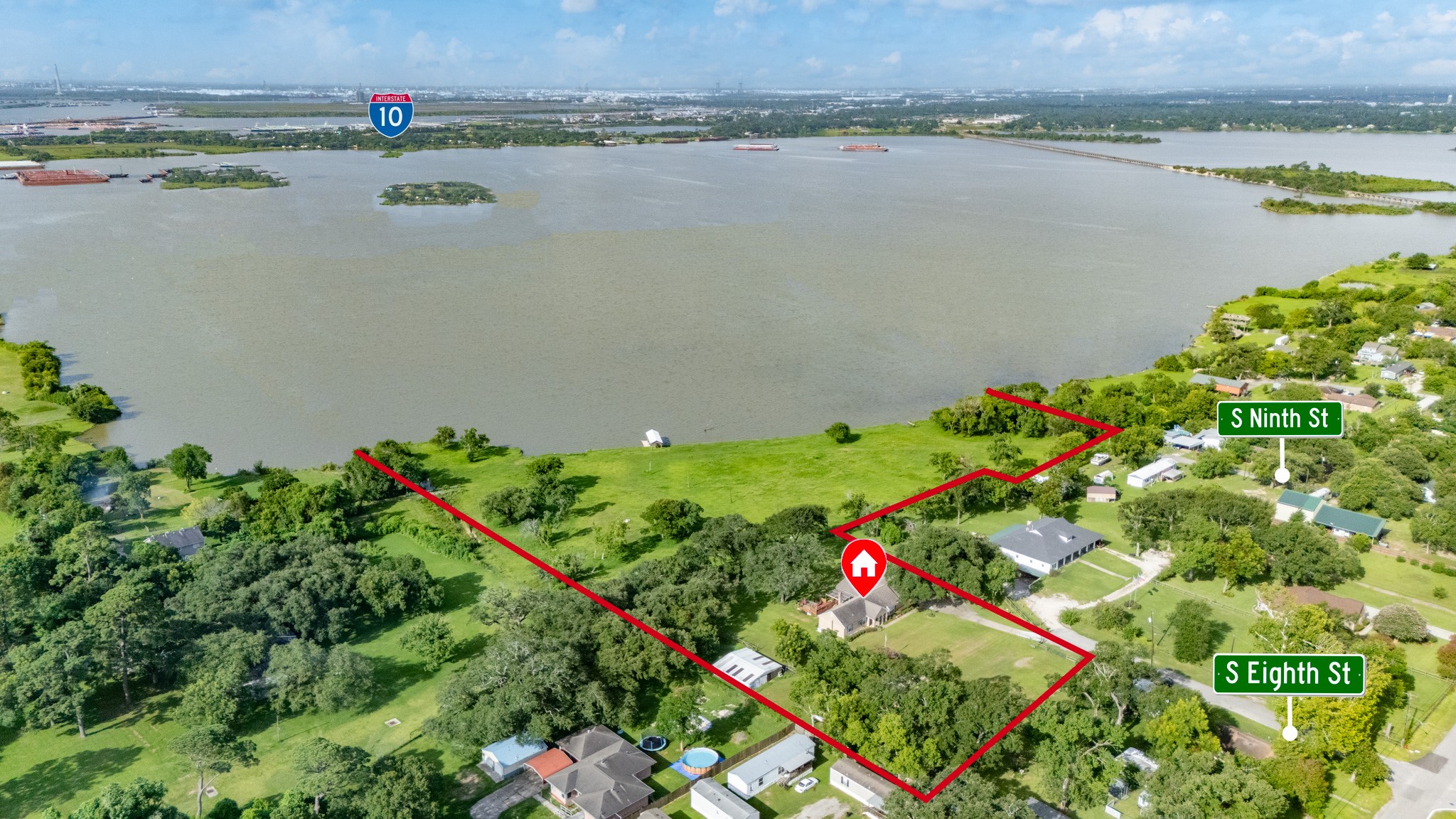 111 South 8th Street Highlands, TX 77562 - Photo 44 of 50 a view of a lake with a field