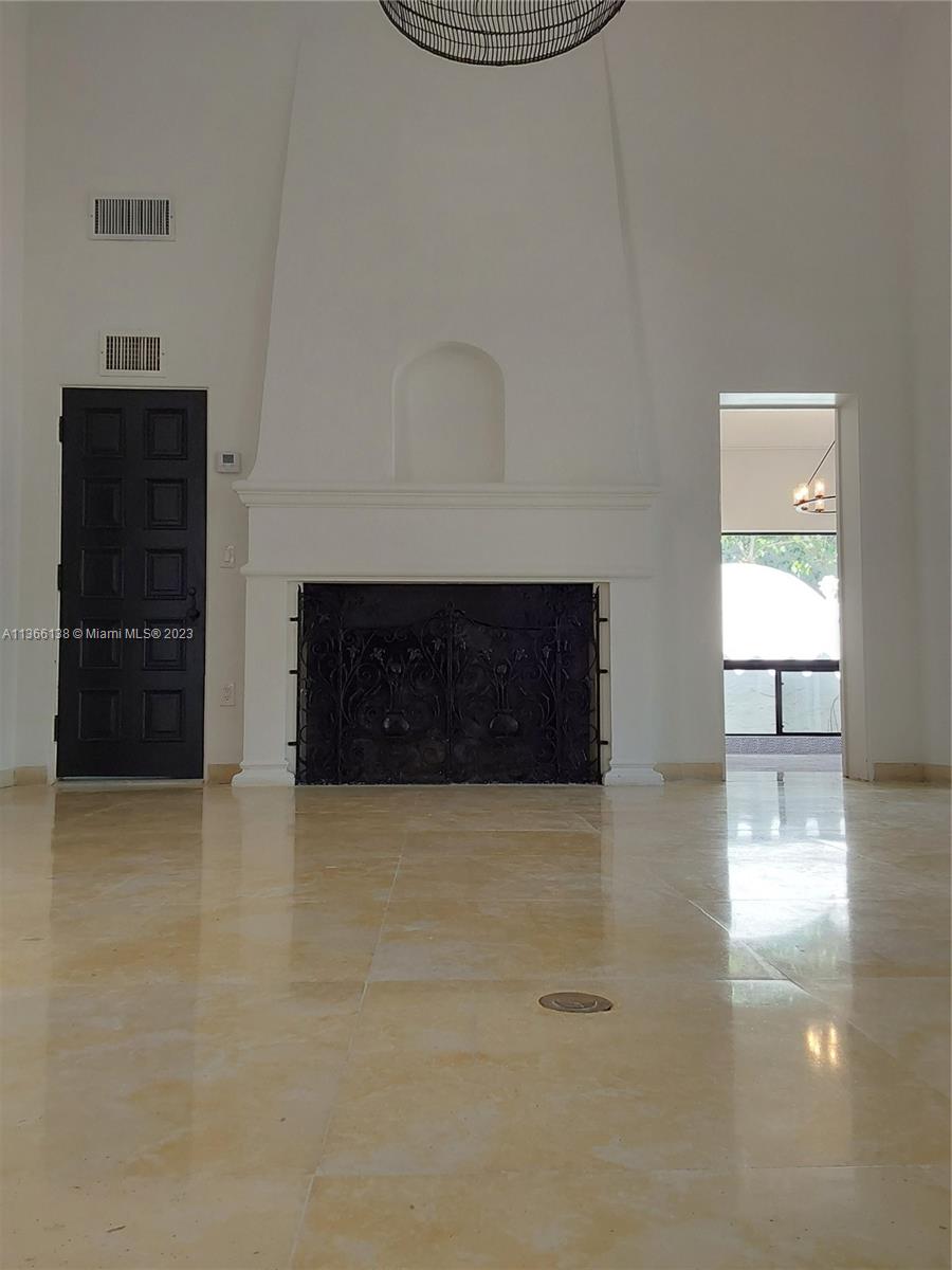 La Gorce Miami Beach, FL 33140 - Photo 29 of 33 a view of a livingroom with wooden floor and a fireplace