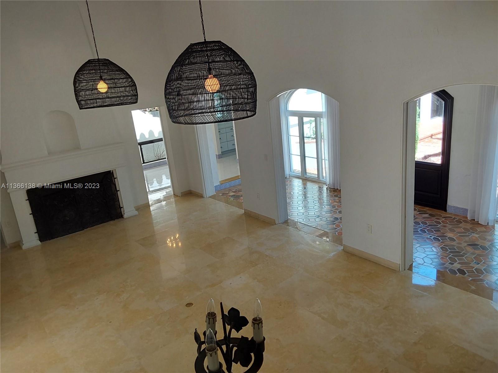 La Gorce Miami Beach, FL 33140 - Photo 3 of 33 an empty room with windows and wooden floor