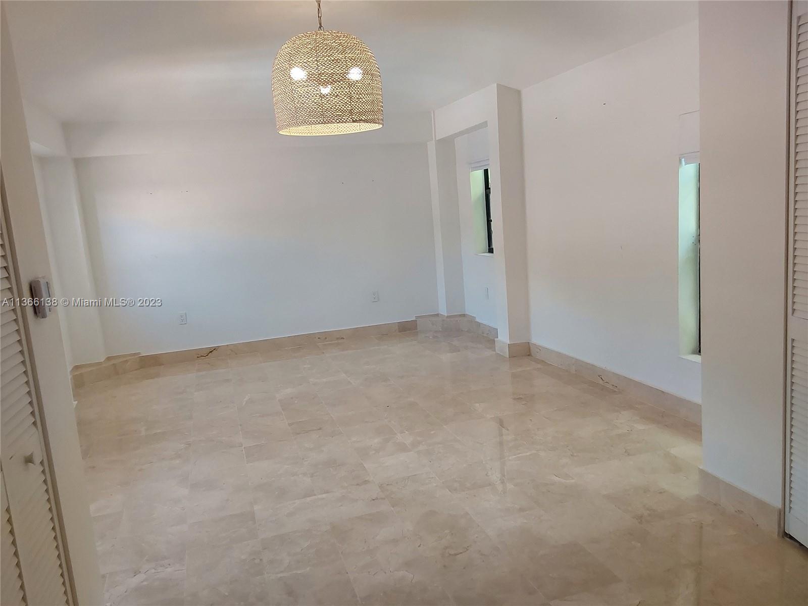 La Gorce Miami Beach, FL 33140 - Photo 33 of 33 an empty room with chandelier fan