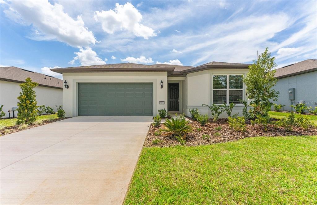 8206 Southwest 52nd Lane Road Ocala, FL 34481 - Photo 1 of 1 a front view of a house with garden