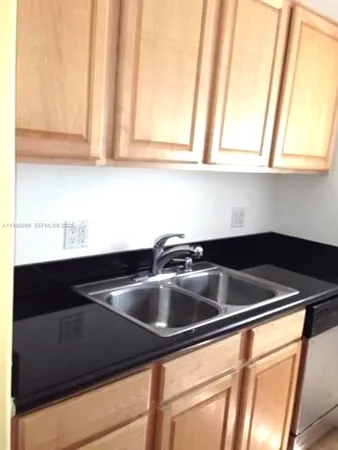 a close view of sink and washing machine