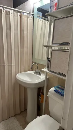 a bathroom with sink and mirror