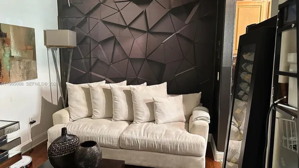 a white couch sitting next to a wooden floor