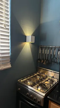 a stove top oven sitting inside of a kitchen