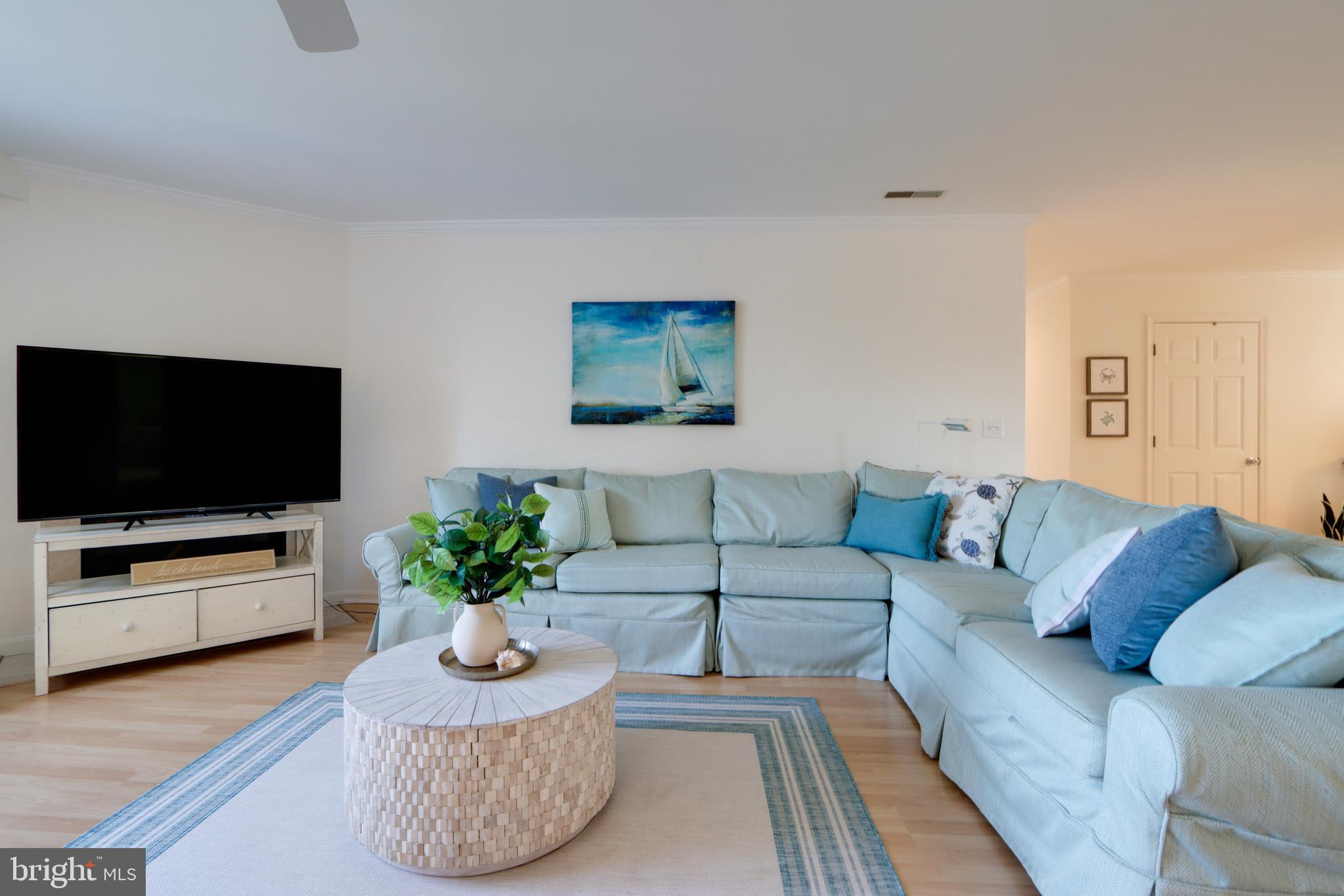24 Brooklyn Avenue, Unit E Rehoboth Beach, DE 19971 - Photo 14 of 74 a living room with furniture and a flat screen tv