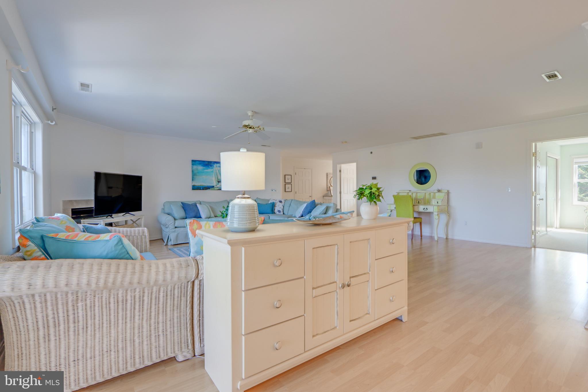 24 Brooklyn Avenue, Unit E Rehoboth Beach, DE 19971 - Photo 17 of 74 a bedroom with furniture and a flat screen tv