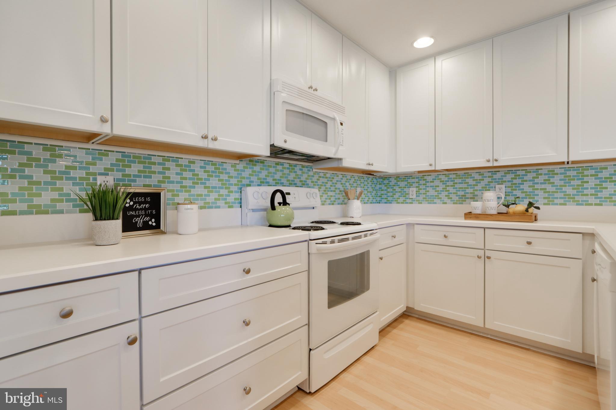 24 Brooklyn Avenue, Unit E Rehoboth Beach, DE 19971 - Photo 22 of 74 a kitchen with stainless steel appliances granite countertop white cabinets a sink and dishwasher