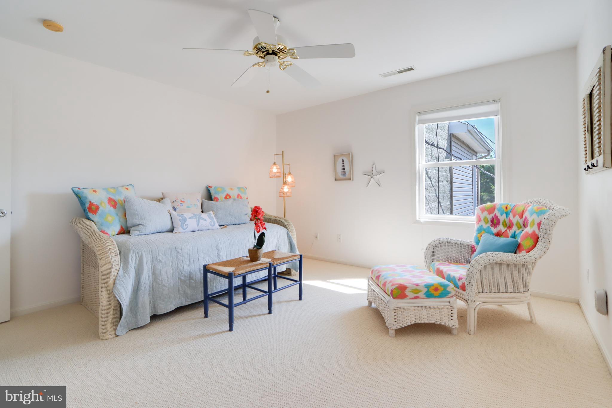 24 Brooklyn Avenue, Unit E Rehoboth Beach, DE 19971 - Photo 36 of 74 a living room with furniture and a chandelier
