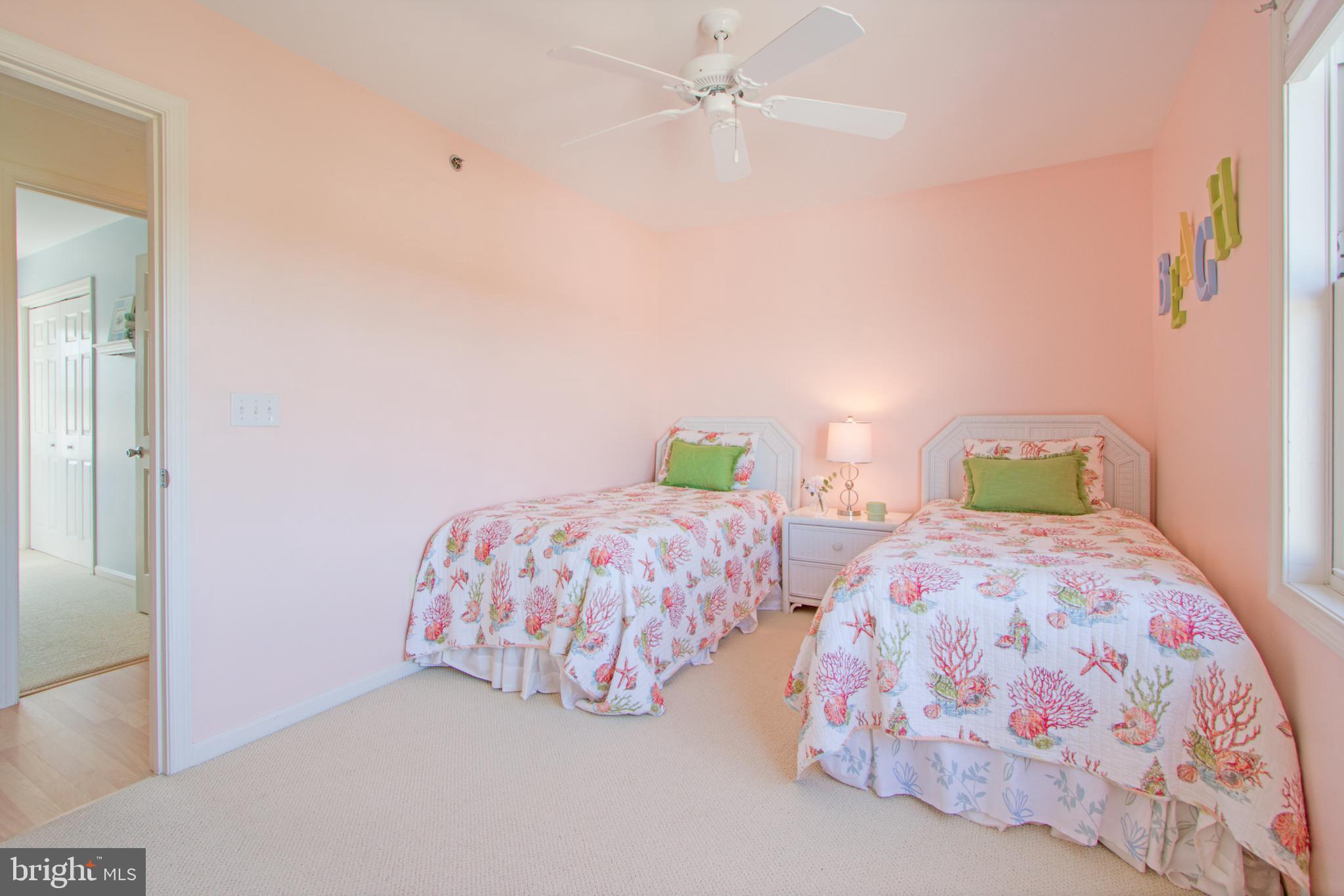 24 Brooklyn Avenue, Unit E Rehoboth Beach, DE 19971 - Photo 42 of 74 a bedroom with two beds and painting on the wall