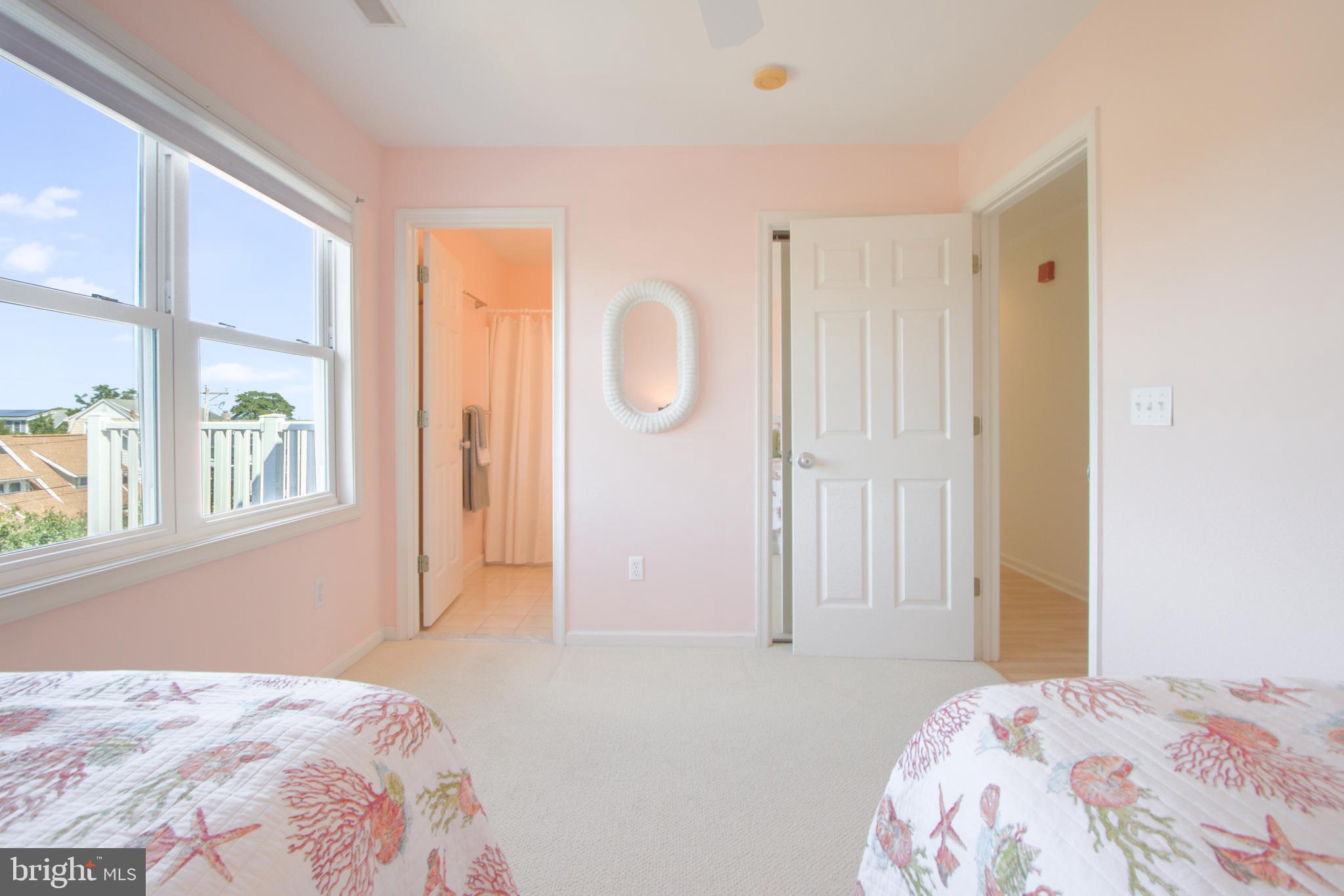 24 Brooklyn Avenue, Unit E Rehoboth Beach, DE 19971 - Photo 43 of 74 a bedroom with a bed and a window