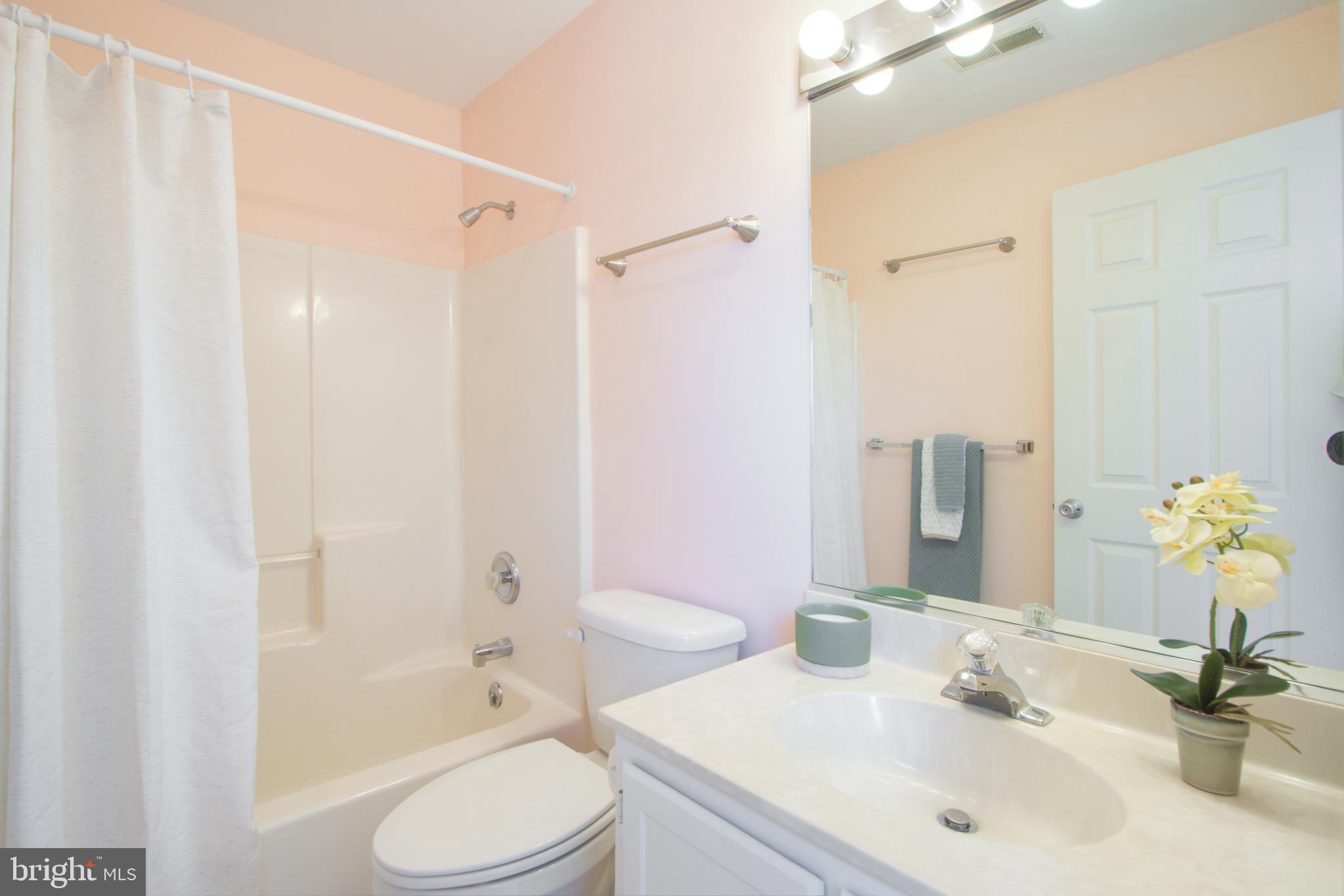 24 Brooklyn Avenue, Unit E Rehoboth Beach, DE 19971 - Photo 44 of 74 a bathroom with a sink toilet and shower